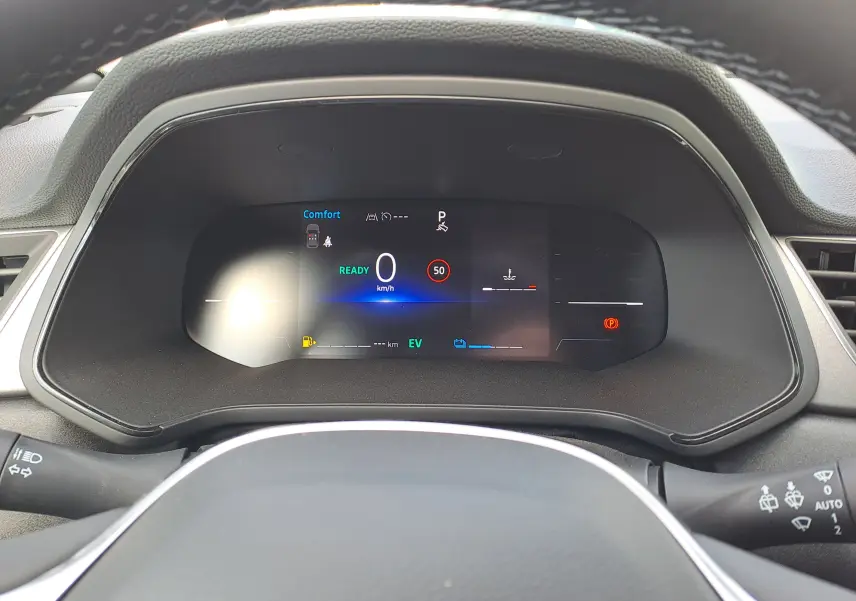 Tableau de bord numérique du Renault Captur 2025 hybride, affichant vitesse, mode confort et indicateurs de conduite.