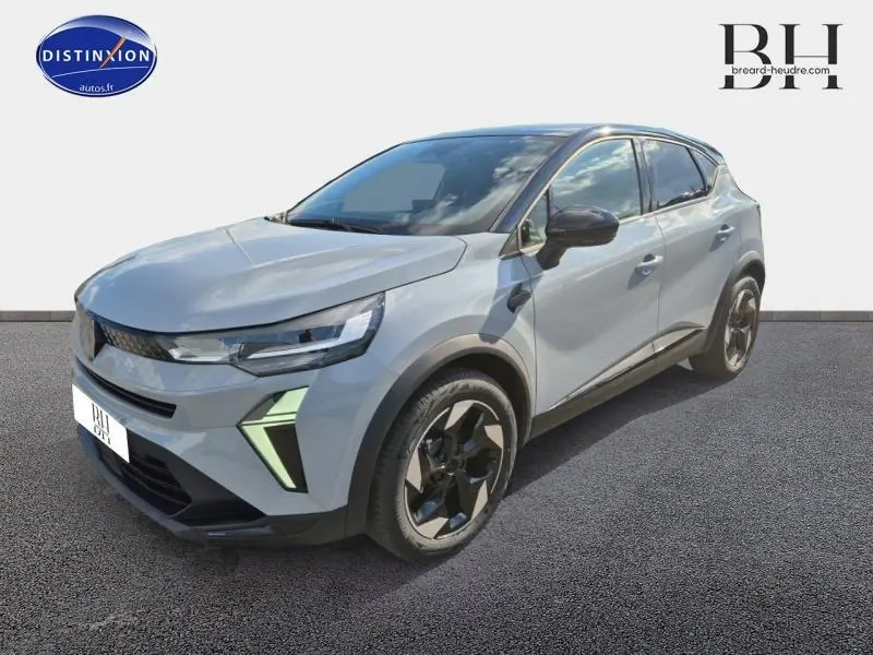 Renault Captur 2025 gris Rafale avec toit noir, vue 3/4 avant droit mettant en valeur ses phares LED et jantes alu noires.