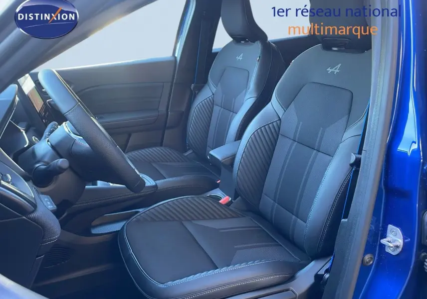 Vue intérieure côté conducteur de la Renault Symbioz 2025 bleu iron metal, sièges en cuir noir avec logo Alpine brodé.