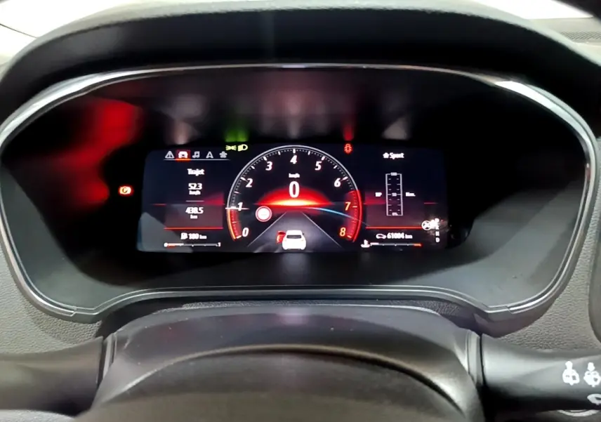 Gros plan sur le combiné d'instruments numérique de la Renault Mégane 2023, affichage rouge et noir sportif.