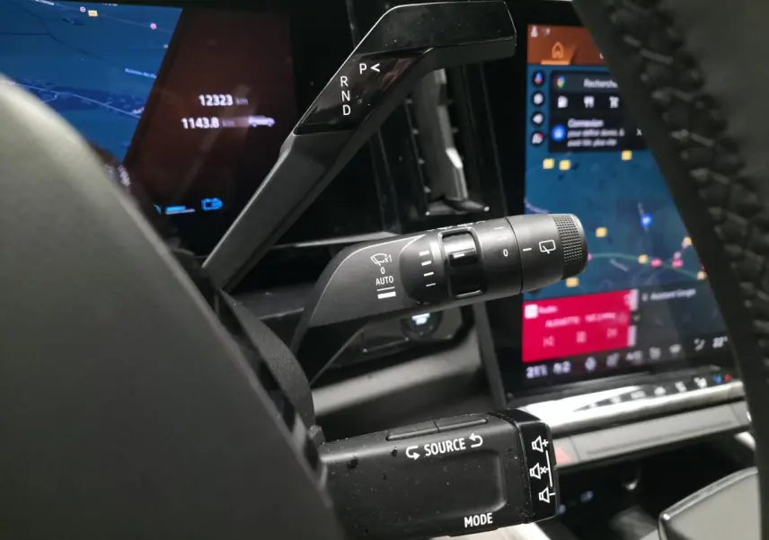 Gros plan sur les commandes au volant du Renault Espace gris 2025, avec affichage numérique et leviers multifonctions.