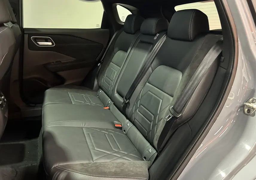 Banquette arrière en cuir noir avec surpiqûres, vue côté gauche du Nissan Qashqai gris céramique 2025.