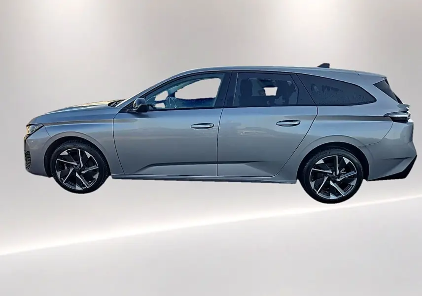 Peugeot 308 SW gris artense vue de profil côté gauche, avec jantes alliage noires et vitres surteintées.
