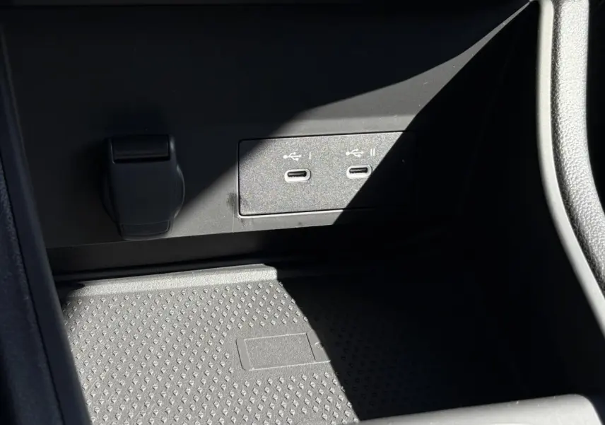 Gros plan sur les ports USB-C et prise 12V dans le compartiment avant du Renault Captur Blanc Nacré 2025.