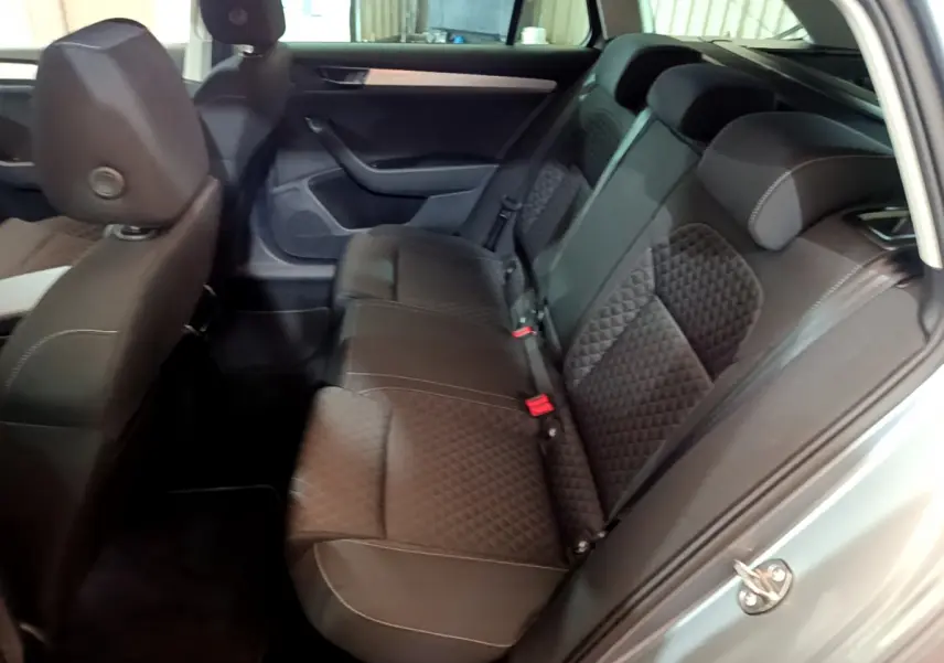 Vue intérieure côté droit sur la banquette arrière en tissu noir matelassé d'une Skoda Superb gris clair 2020.