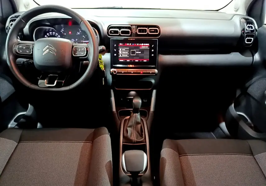 Intérieur Citroën C3 Aircross 2019 vu de face, tableau de bord noir avec écran tactile central et volant cuir multifonctions.