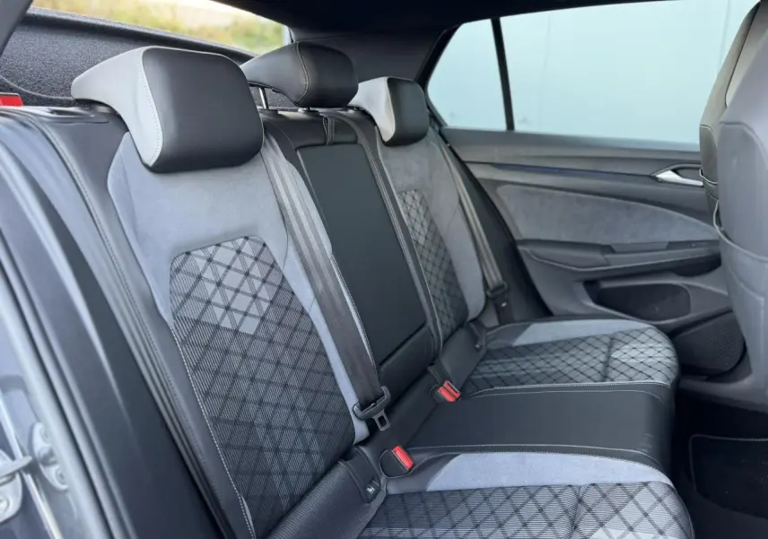 Vue latérale droite de l’arrière intérieur de la Volkswagen Golf 8 R-Line 2024 avec sellerie tissu gris et motifs géométriques.