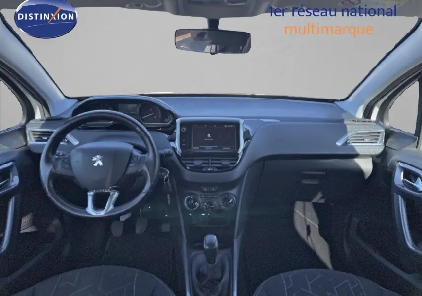 Vue intérieure avant du tableau de bord et volant noir du Peugeot 2008 blanc, avec écran tactile central et commandes manuelles.