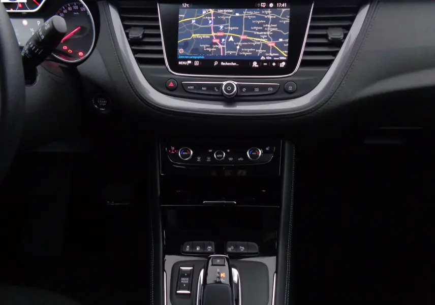Intérieur de l'Opel Grandland X 1.6 Hybrid Turbo 2021, tableau de bord avec écran GPS et console centrale noire.