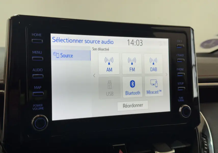 Gros plan sur l'écran tactile central de la Toyota Corolla Hybride 122h Collection 2021, affichant les options audio.