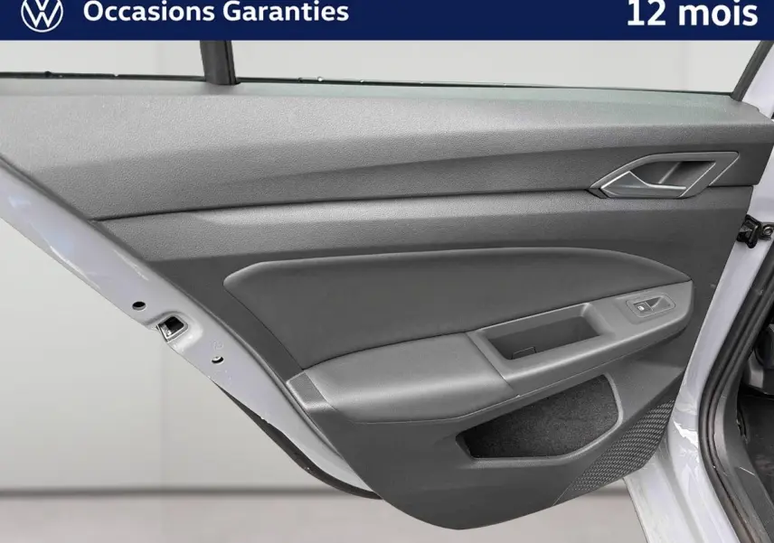 Porte arrière droite ouverte de la Volkswagen Golf 1.5 eTSI 2025 gris, montrant le panneau intérieur gris avec commande de vitre.