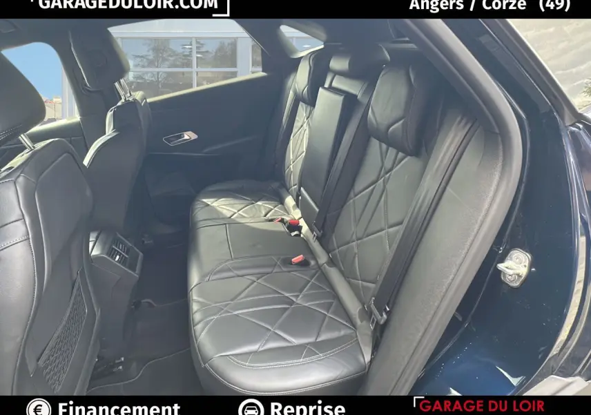 Vue intérieure sur la banquette arrière en cuir noir matelassé du DS7 bleu saphir, avec portières ouvertes côté droit.