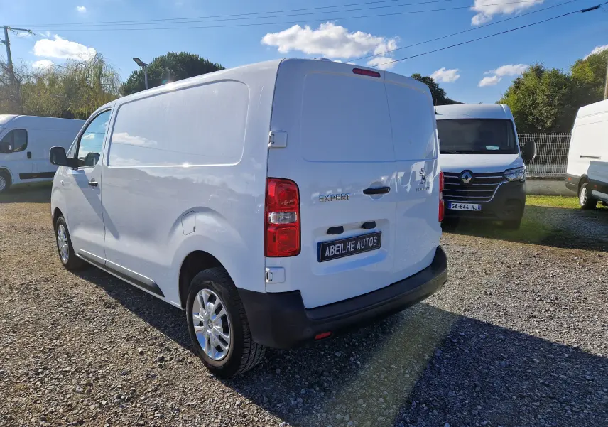Vue 3/4 arrière droite d'un Peugeot Expert Fourgon blanc 2020, avec logo et plaque Abeilhe Autos visibles.