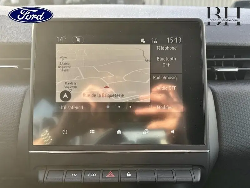 Écran tactile central affichant la navigation dans une Renault Clio gris Titanium vue de face intérieure.
