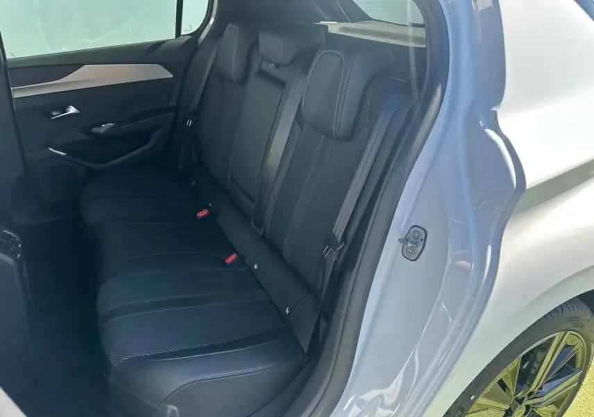 Vue côté gauche de la banquette arrière noire d'une Peugeot 308 blanche avec jantes alliage 18 pouces Portland.