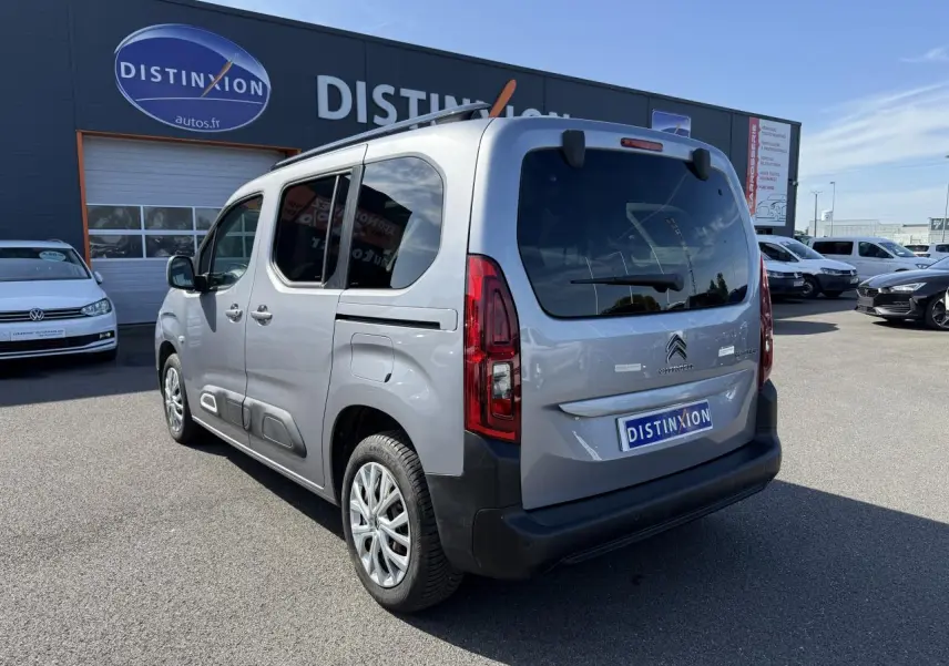 Vue 3/4 arrière droite d'un Citroën Berlingo gris foncé avec vitres arrière surteintées et lunette ouvrante.