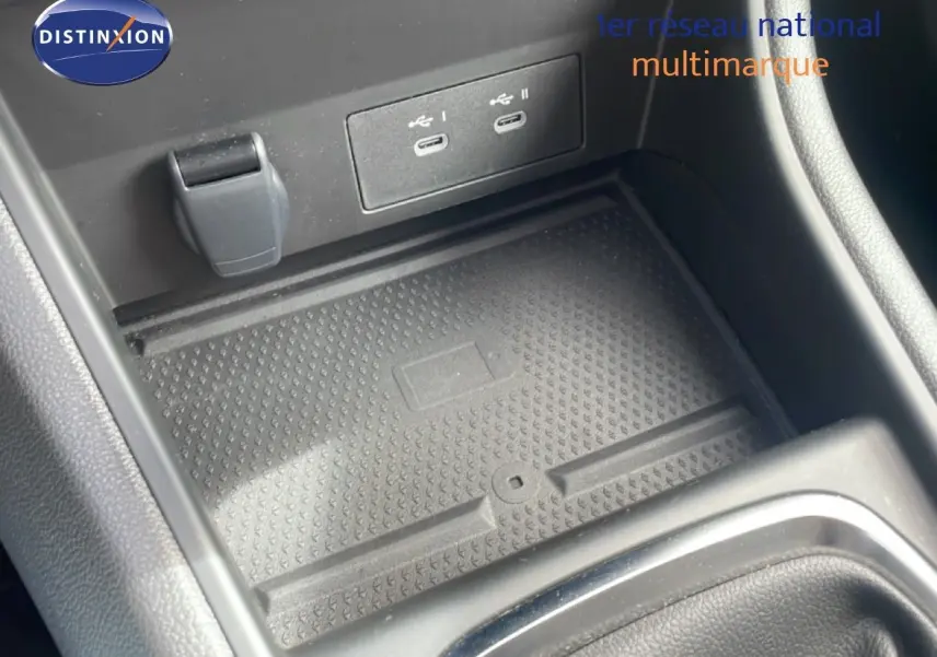 Gros plan sur la console centrale du Renault Captur 2025 avec ports USB-C et surface de recharge sans fil.