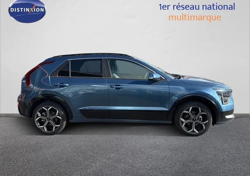 KIA Niro hybride rechargeable bleu minéral métal vu de profil côté gauche, avec jantes bi-ton et lignes modernes.