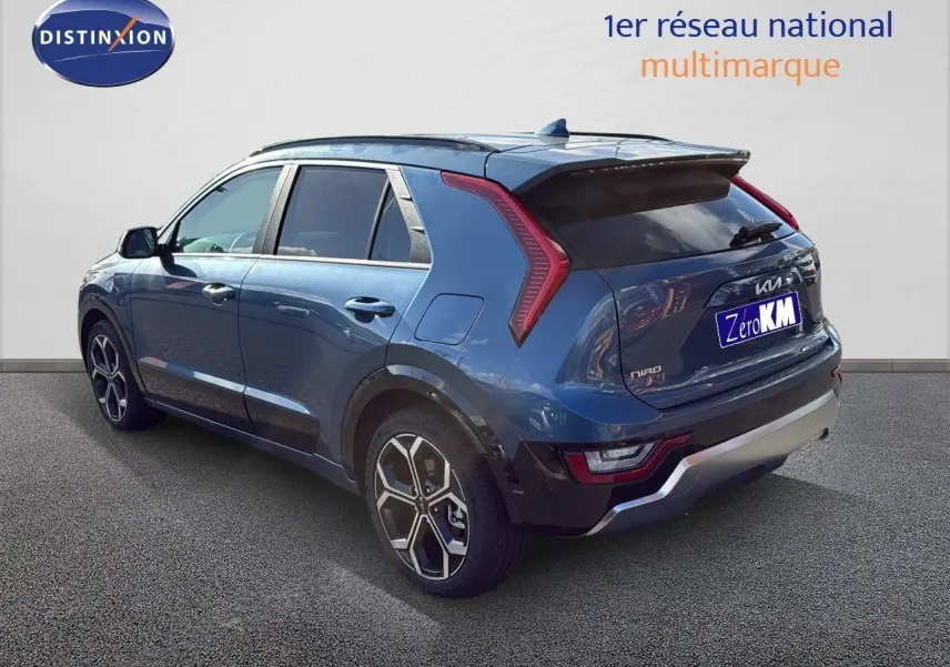 Vue 3/4 arrière droite d'un KIA NIRO bleu minéral métal 2025 avec feux LED et jantes bi-ton distinctives.