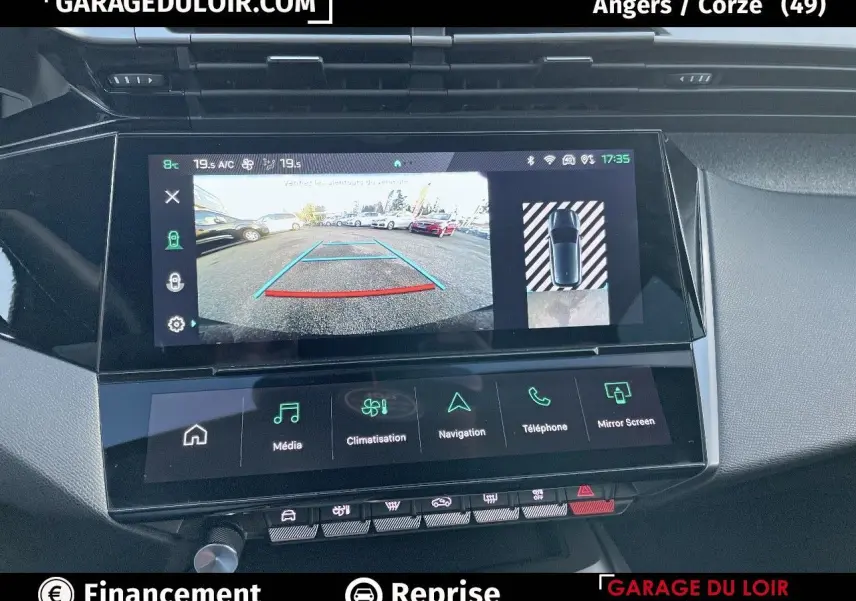 Vue rapprochée de l'écran tactile central de la Peugeot 308 gris Artense affichant la caméra de recul et les commandes multimédia.