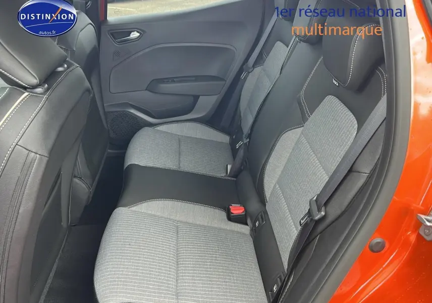 Vue intérieure du côté droit sur la banquette arrière grise et noire d'une Renault Clio V orange Valencia avec porte ouverte.