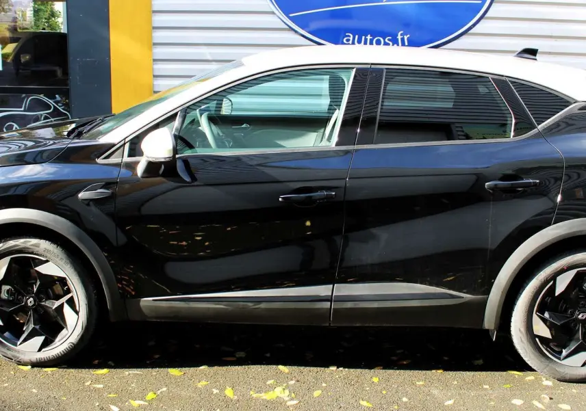Profil côté gauche du Renault Captur 2025 noir métal avec toit gris, jantes noires au design géométrique.