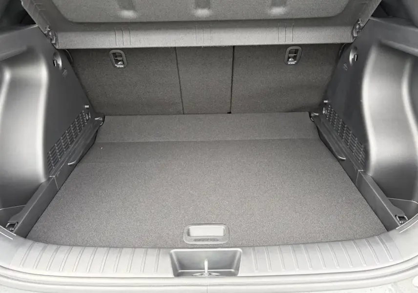 Coffre ouvert de Hyundai Kona 2026 gris Ecotronic, montrant un espace de chargement propre et bien fini.