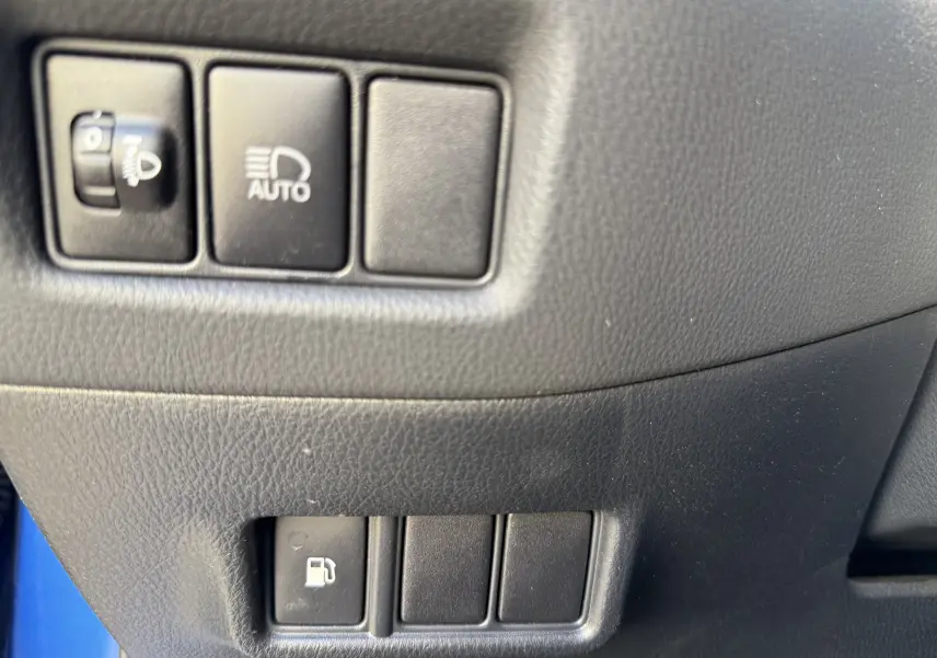 Gros plan sur les commandes noires du tableau de bord côté gauche du Toyota C-HR bleu Nebula Hybrid 2018.