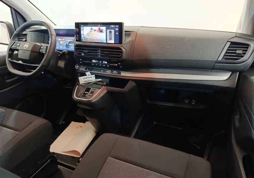 Vue intérieure avant du Citroën Jumpy XL 2025 noir, tableau de bord avec écran tactile et volant multifonctions.