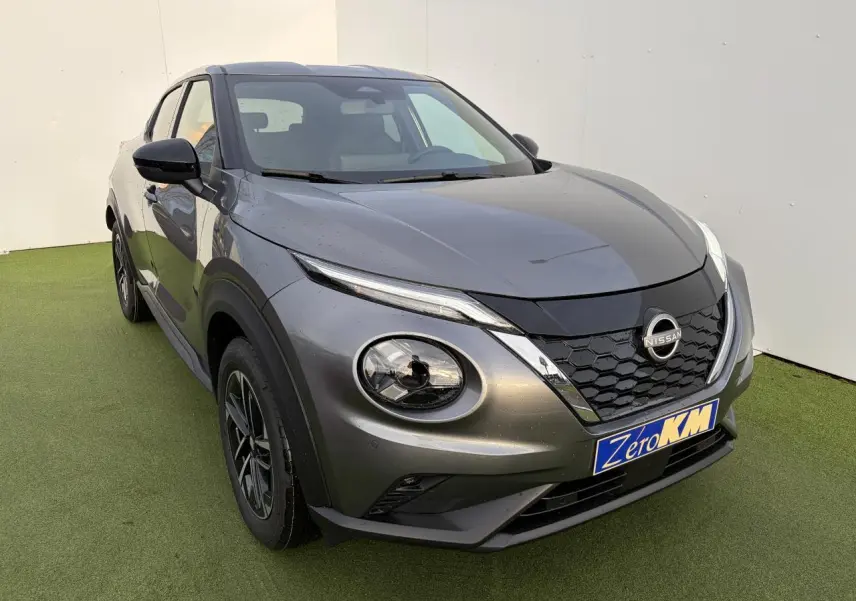 Nissan Juke II 1.6 Hybrid noir métal vu en 3/4 avant gauche avec calandre en nid d'abeille et phares LED ronds.