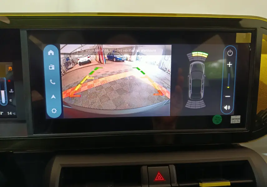 Écran tactile central de la Fiat Grande Panda jaune montrant la caméra de recul et l’aide au stationnement arrière.