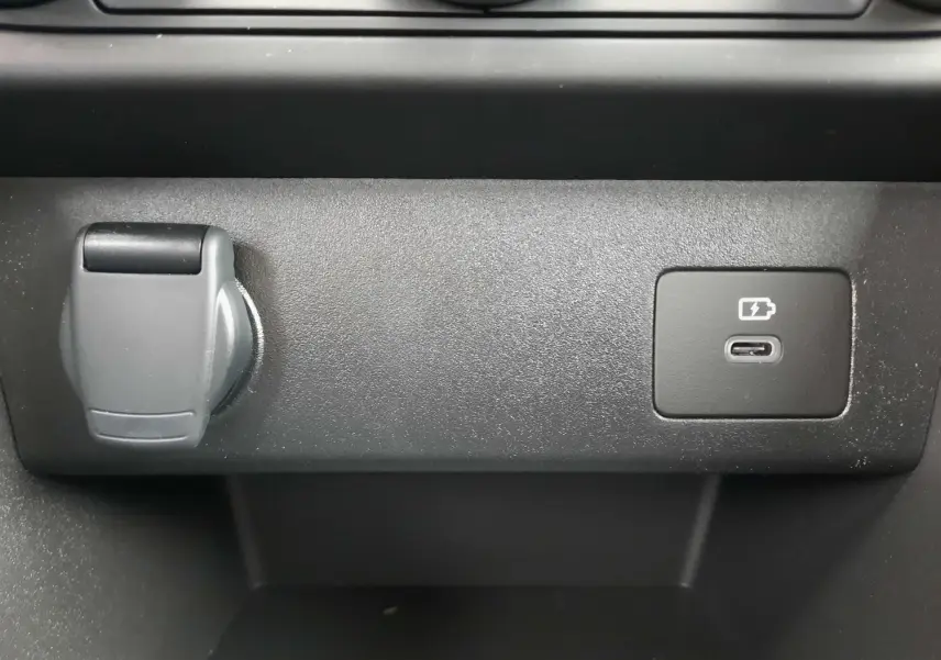Gros plan sur la prise USB-C et l’allume-cigare dans l’habitacle noir du Dacia Sandero Stepway 2025