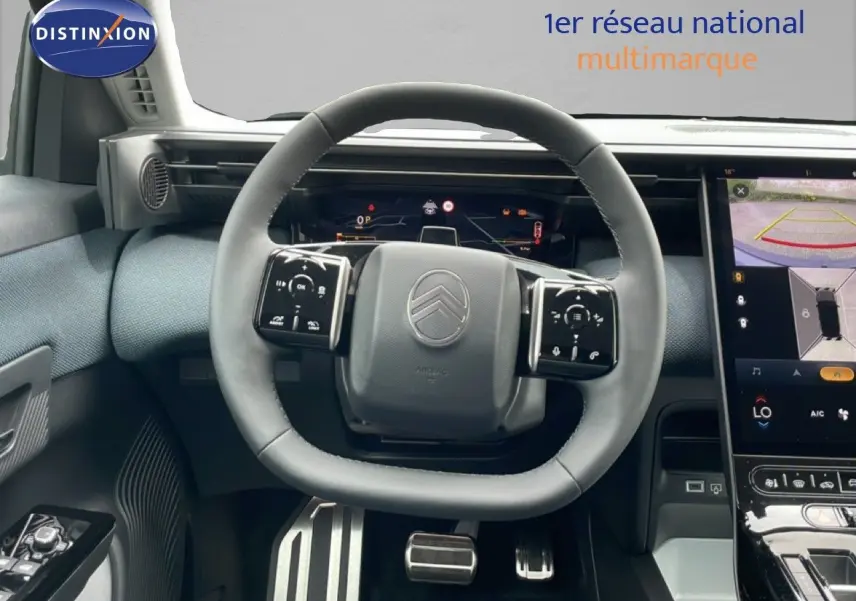 Vue intérieure centrée sur le volant gris du Citroën C5 Aircross 2026 avec tableau de bord numérique et écran tactile.