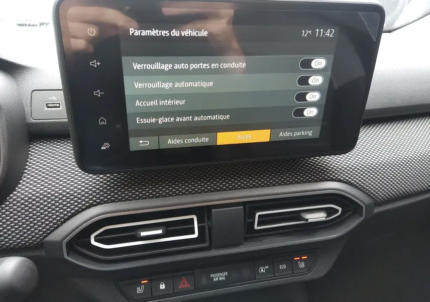 Écran tactile du tableau de bord de la Dacia Sandero 2025, avec réglages d'aides à la conduite visibles.
