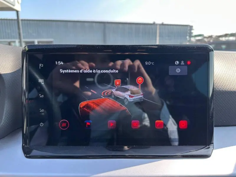Écran tactile intérieur affichant les systèmes d'aide à la conduite du SEAT Arona 2025, vue frontale du tableau de bord.