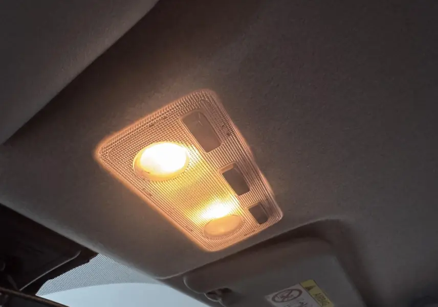 Plafonnier intérieur allumé de la Toyota Yaris 1.5 VVT-I Hybrid 2019, vue du plafond cabine en gris foncé.