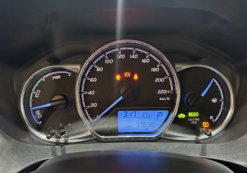 Vue rapprochée du tableau de bord de la Toyota Yaris hybride 2019, affichage digital bleu et voyants allumés.