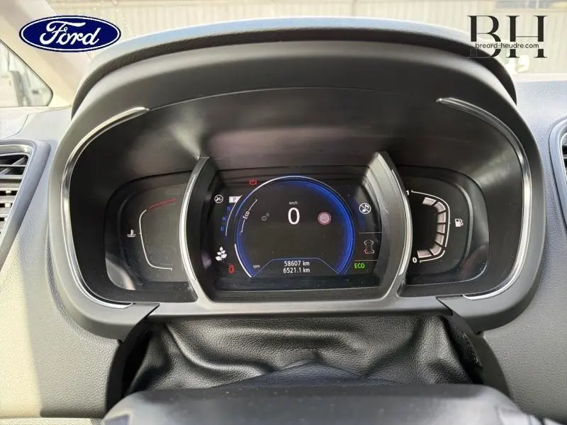 Tableau de bord numérique d'un Renault Grand Scenic gris Cassiopée, vue frontale centrée sur l'écran multifonction.
