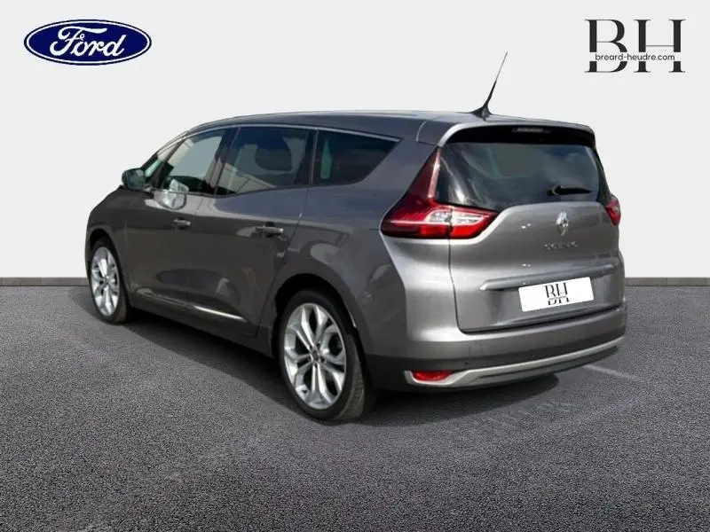 Vue 3/4 arrière droite d'un Renault Grand Scenic gris Cassiopée avec jantes alu et vitres surteintées.