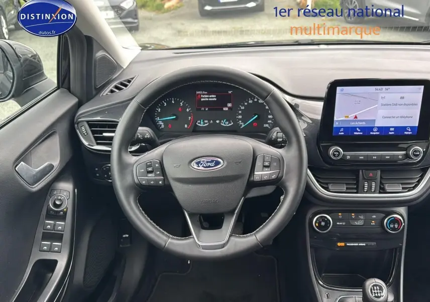 Intérieur de la Ford Puma 2023, vue centrée sur le volant multifonction et l'écran tactile du tableau de bord.