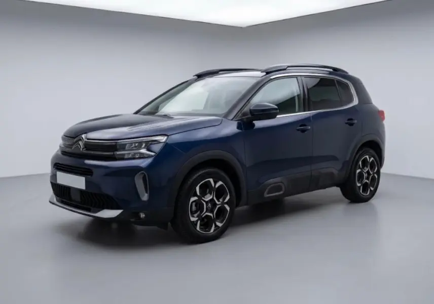 Citroën C5 Aircross hybride 2024 bleu foncé, vue 3/4 avant droit avec jantes au design hexagonal distinctif.