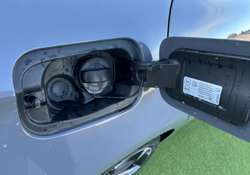 Gros plan sur la trappe à carburant côté gauche d'une CUPRA Leon gris Graphene avec bouchon essence ouvert.