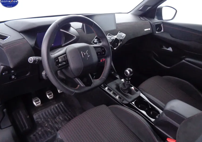 Intérieur noir du DS3 Crossback 2021, vue côté conducteur sur le volant, levier de vitesse manuel et tableau de bord moderne.
