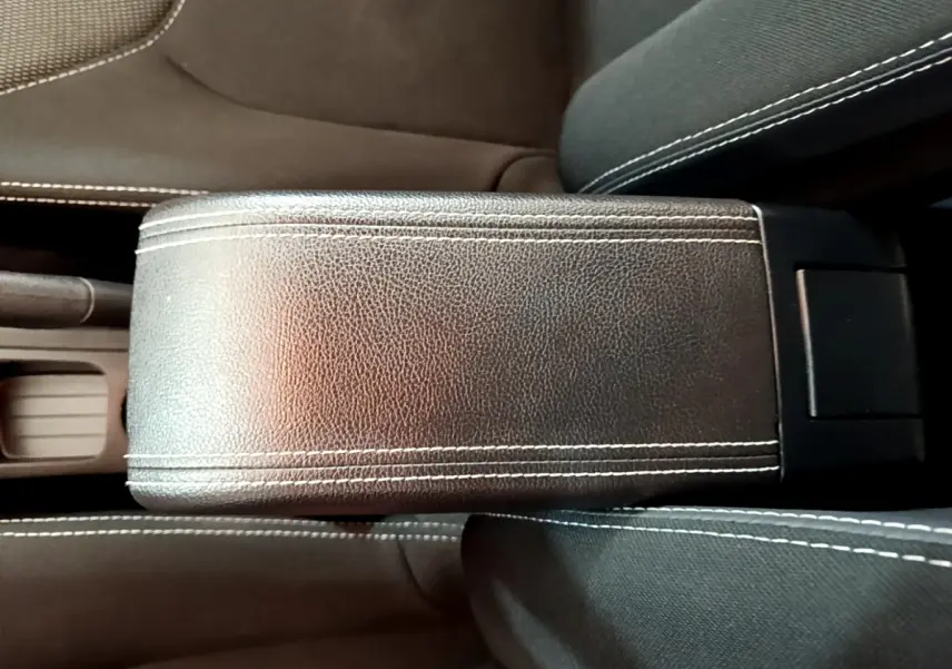 Gros plan sur l'accoudoir central en cuir noir avec surpiqûres blanches de la Renault Clio Business TCe 90 2019.