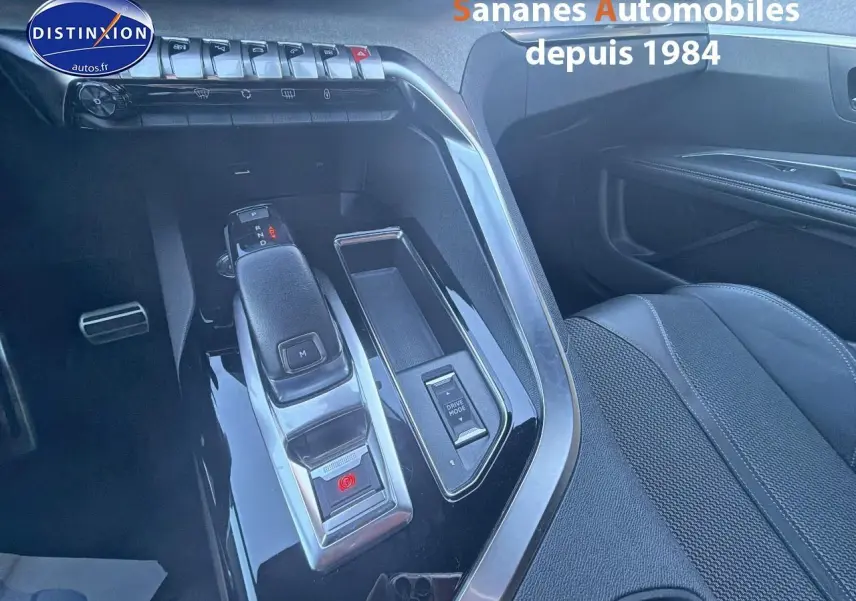 Vue rapprochée de la console centrale noire avec levier de vitesses et bouton Drive Mode du Peugeot 3008 bleu 2023.