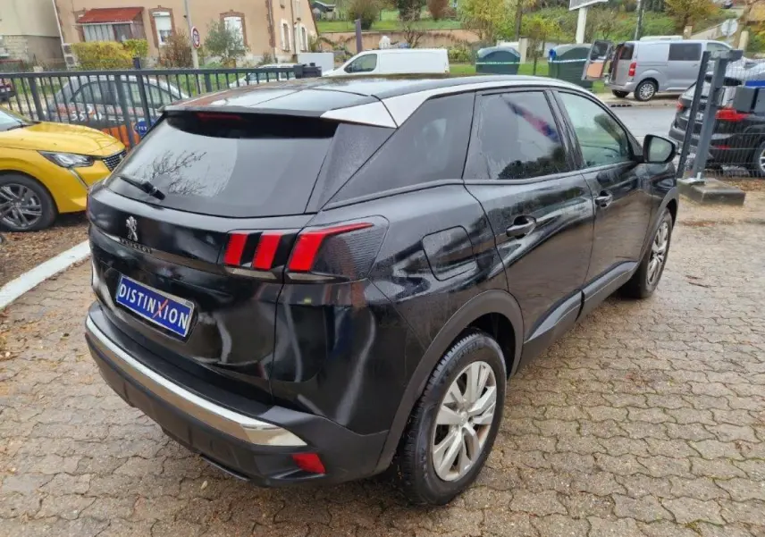 Vue 3/4 arrière droite d'un Peugeot 3008 noir métallisé avec feux arrière à griffes et vitres surteintées.
