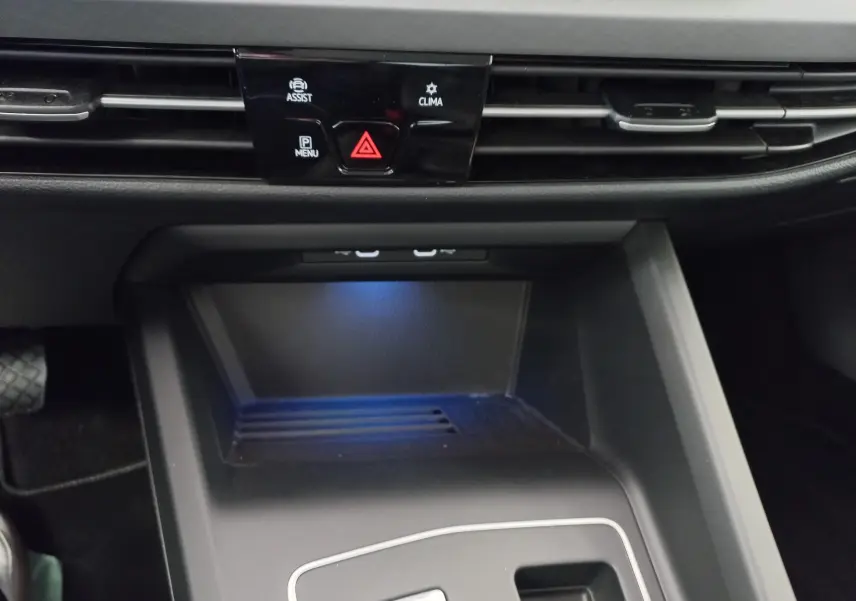Gros plan sur la console centrale noire de la Volkswagen Golf 2.0 TDI 150 DSG7 Style avec éclairage bleu subtil.