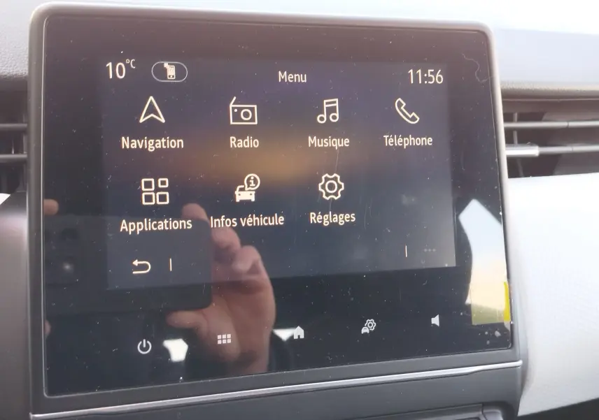 Écran tactile central de la Renault Clio 1.6 E-Tech 2022 affichant le menu principal avec navigation et radio.
