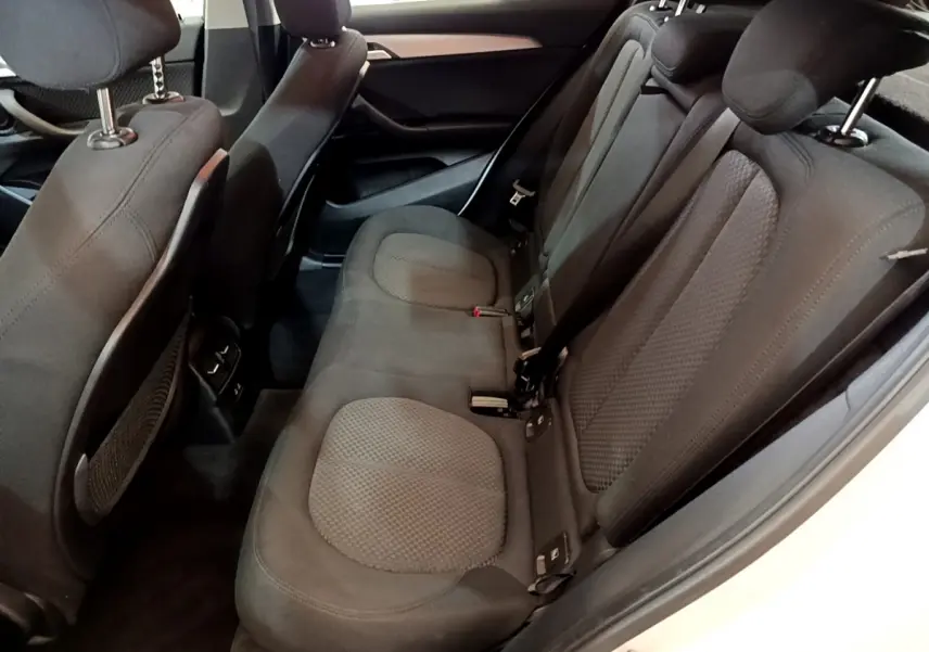 Vue intérieure côté droit des sièges arrière noirs du BMW X2 blanc sDrive18i Business DesignDKG7 2023.