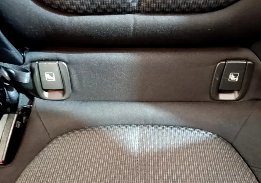 Gros plan sur les commandes de rabattement des sièges arrière du BMW X2 blanc, version sDrive18i Business DesignDKG7.